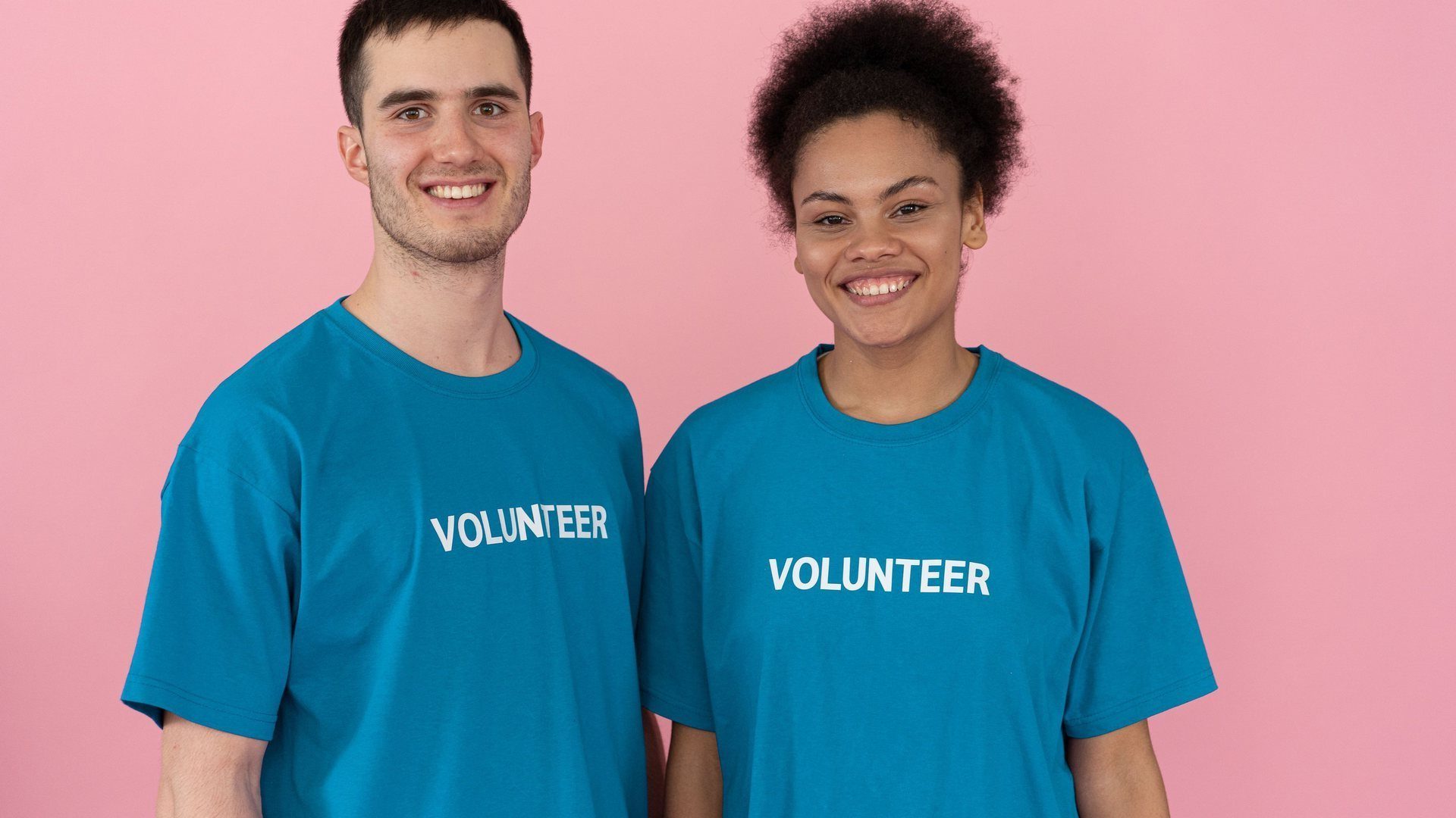Two Hope Delivery Foundation volunteers in branded t-shirts, smiling